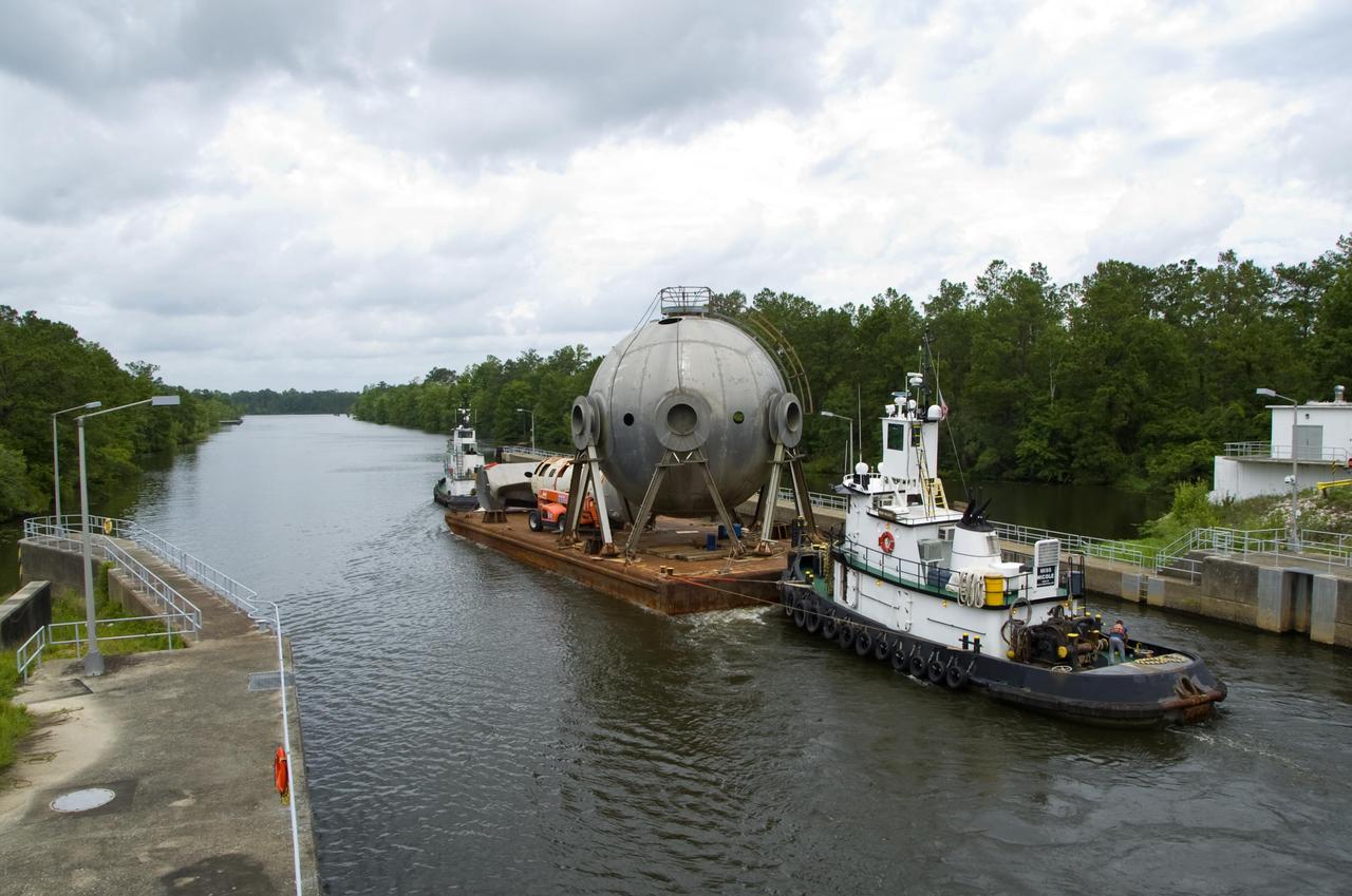 A 107,000-gallon liquid hydrogen sphere no longer needed at Stennis Space Center is barged through the facility locks June 21. The rocket engine test facility has teamed with the Mississippi Department of Marine Resource to place the sphere in offshore waters as an artificial reef.