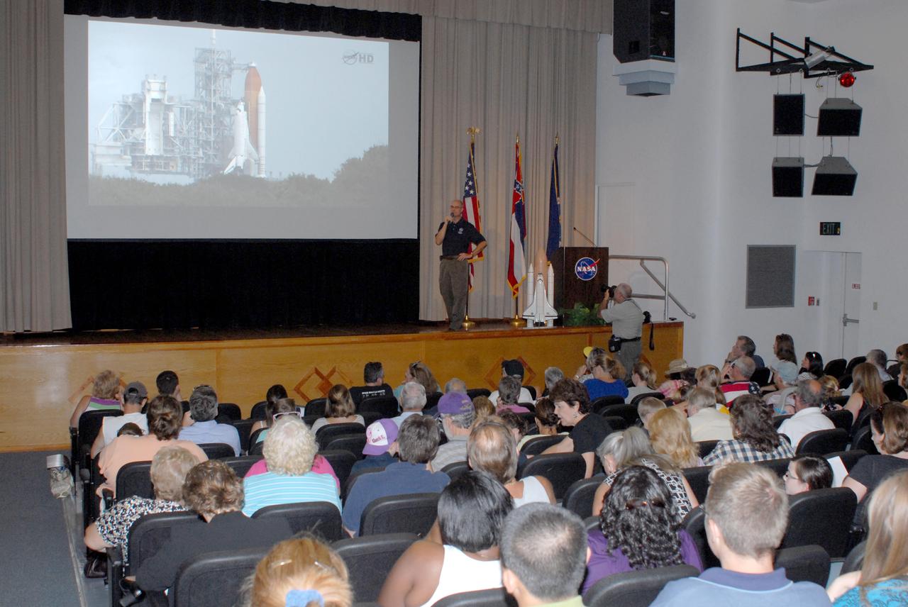 NASA engineer Don Beckmeyer speaks to an audience gathered at StenniSphere auditorium at Stennis Space Center to view the launch of the STS-135 space shuttle mission July 8. The mission marked the final flight for Atlantis and the final flight for the Space Shuttle Program. Viewers applauded and cheered as Atlantis headed to space, powered by a trio of main engines tested at Stennis Space Center.