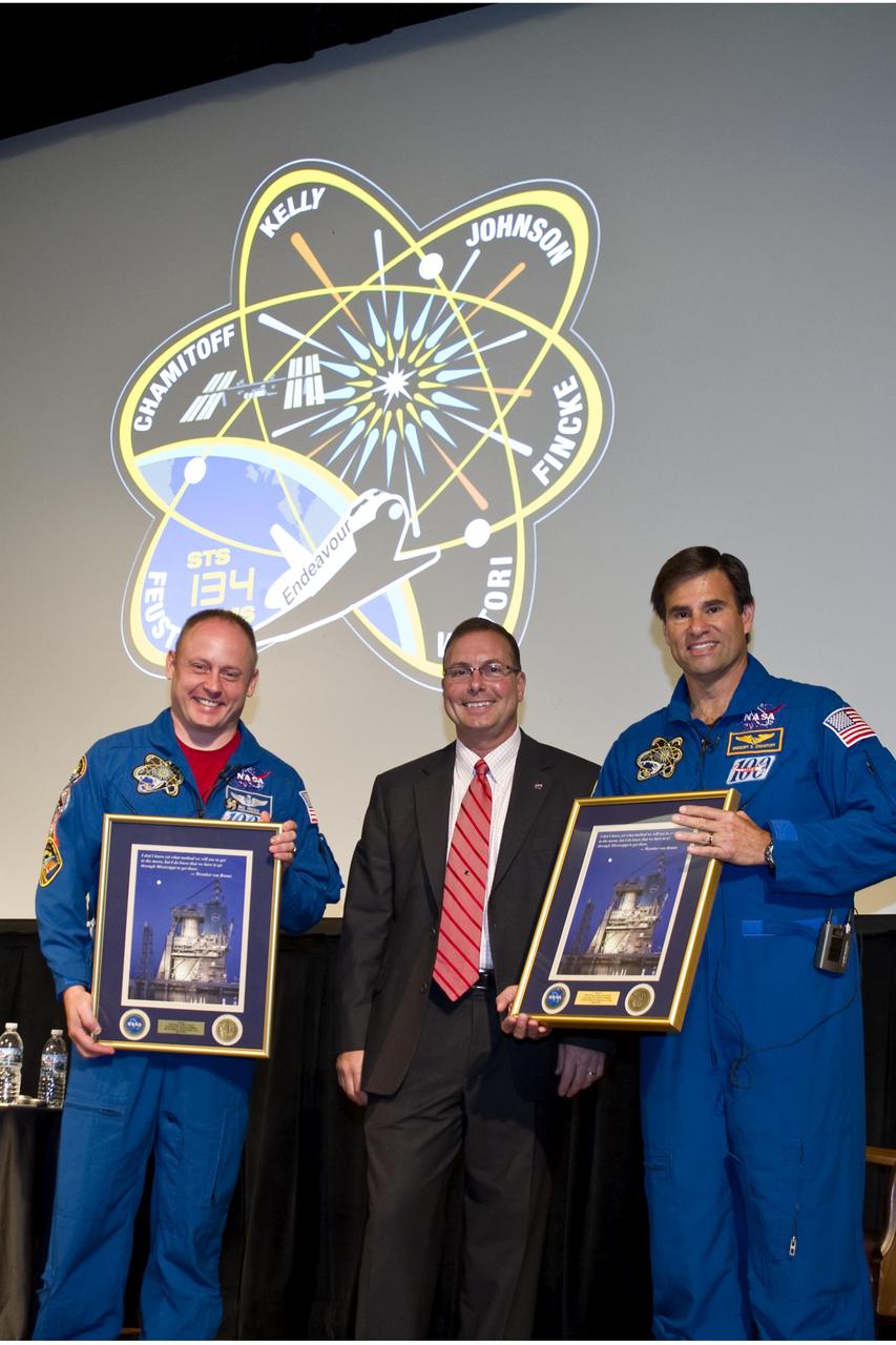 Stennis Space Center Deputy Director Richard Gilbrech (center) presents commemorative plaques to STS-134 crew members Michael Fincke (l) and Gregory Chamitoff during their July 20 visit to the south Mississippi facility. During the visit, Fincke and Chamitoff spoke to Stennis employees about their STS-134 mission aboard shuttle Endeavour, the final flight to space for the NASA orbiter.