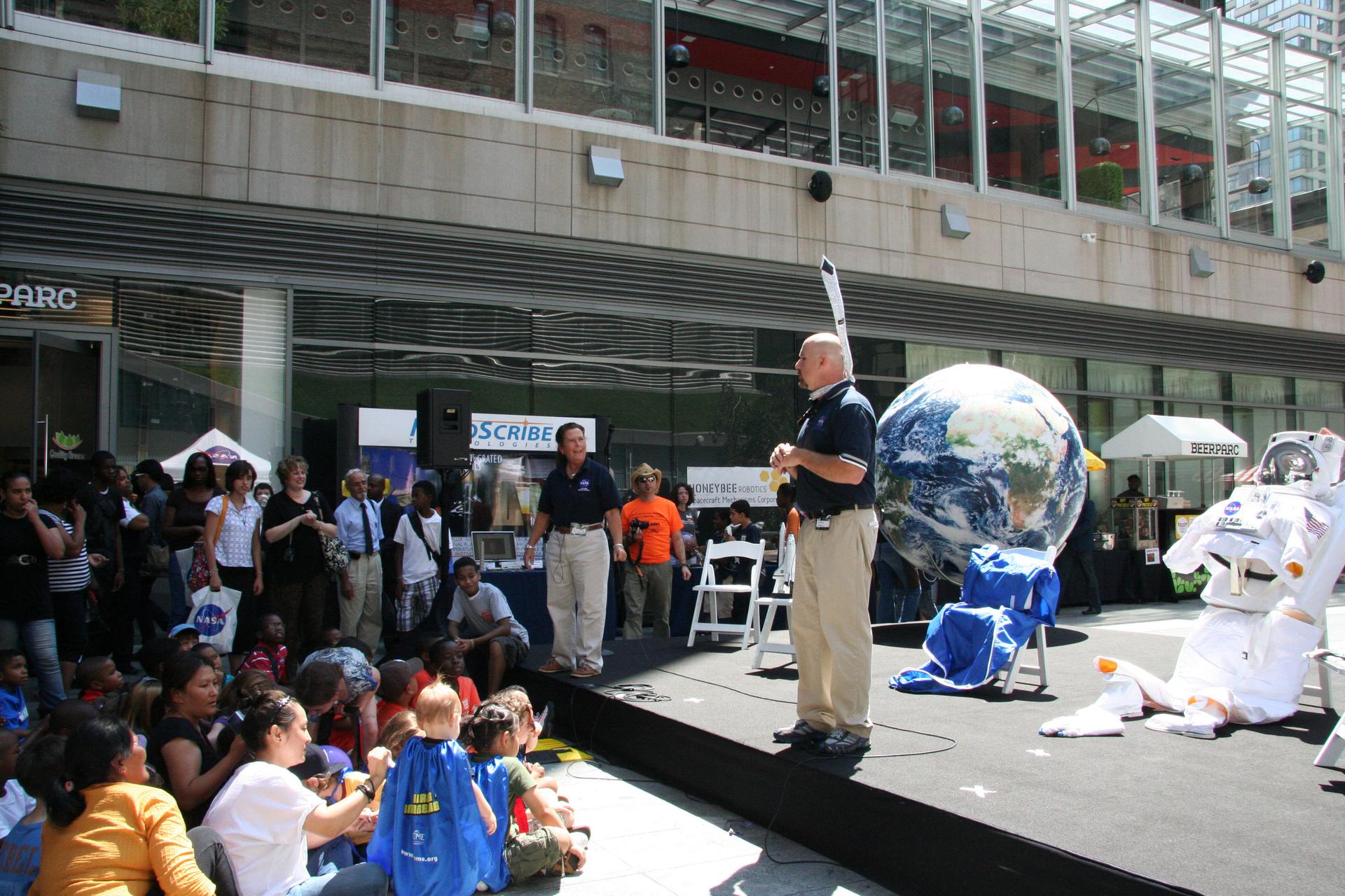 Chris Copelan (right), talking about living and working in space with visitors gathered for the 'What's Your Favorite Space?' event in New York City