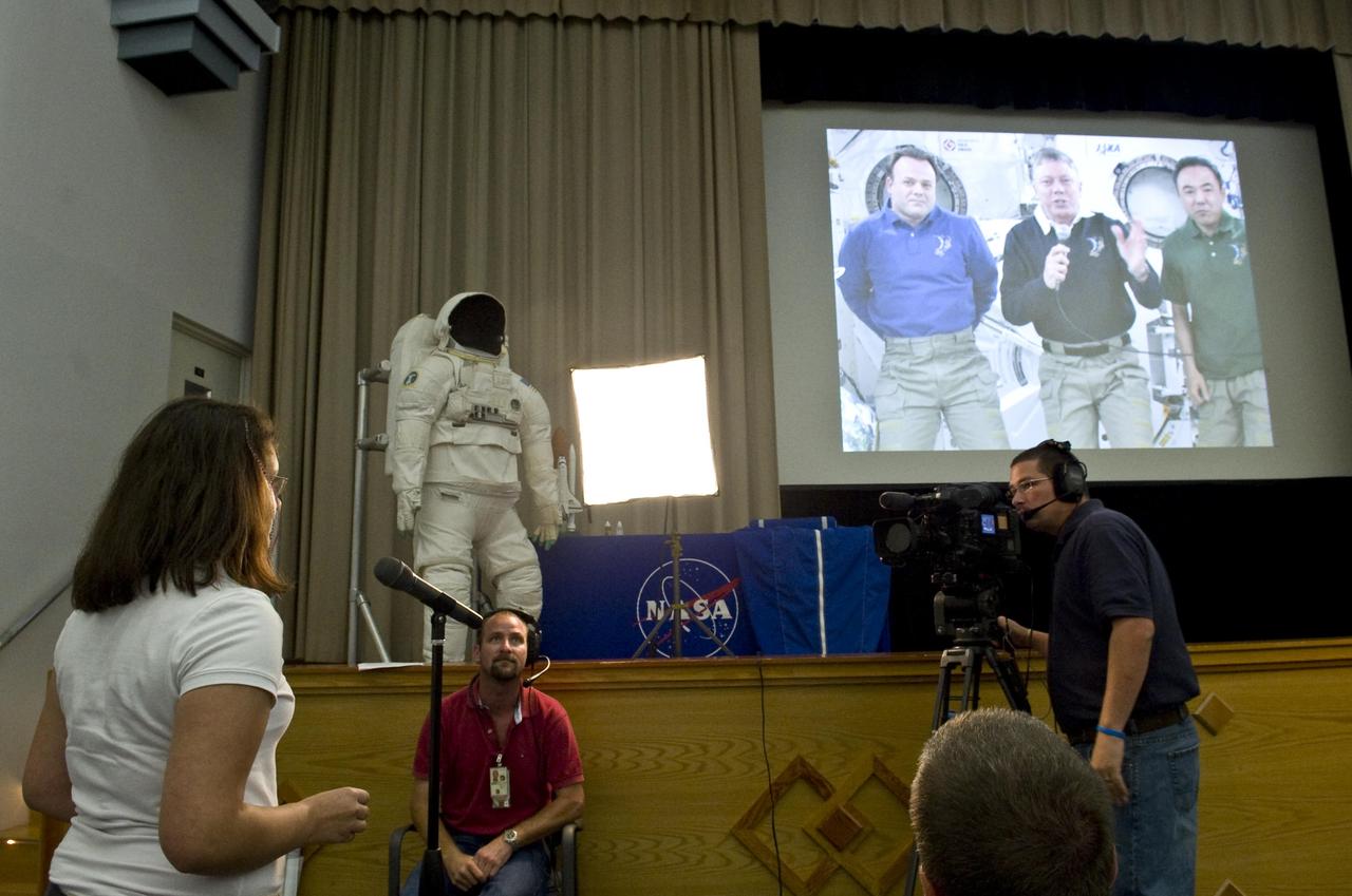 An area student prepares to ask a question of astronauts Ron Garan, Mike Fossum and Satoshi Furukawa during a live video linkup with the International Space Station at Stennis Space Center on Aug. 18. Students from four Louisiana and Mississippi schools gathered at Stennis for the center's first-ever live video link from space.