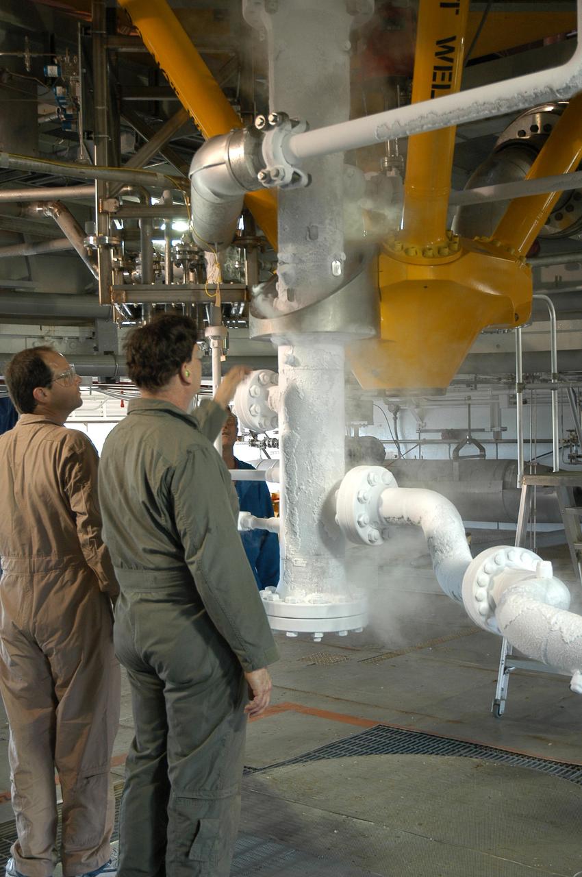 Team members check the progress of a liquid nitrogen cold shock test on the A-1 Test Stand at Stennis Space Center on Sept. 15. The cold shock test is used to confirm the test stand's support system can withstand test conditions, when super-cold rocket engine propellant is piped. The A-1 Test Stand is preparing to conduct tests on the powerpack component of the J-2X rocket engine, beginning in early 2012.