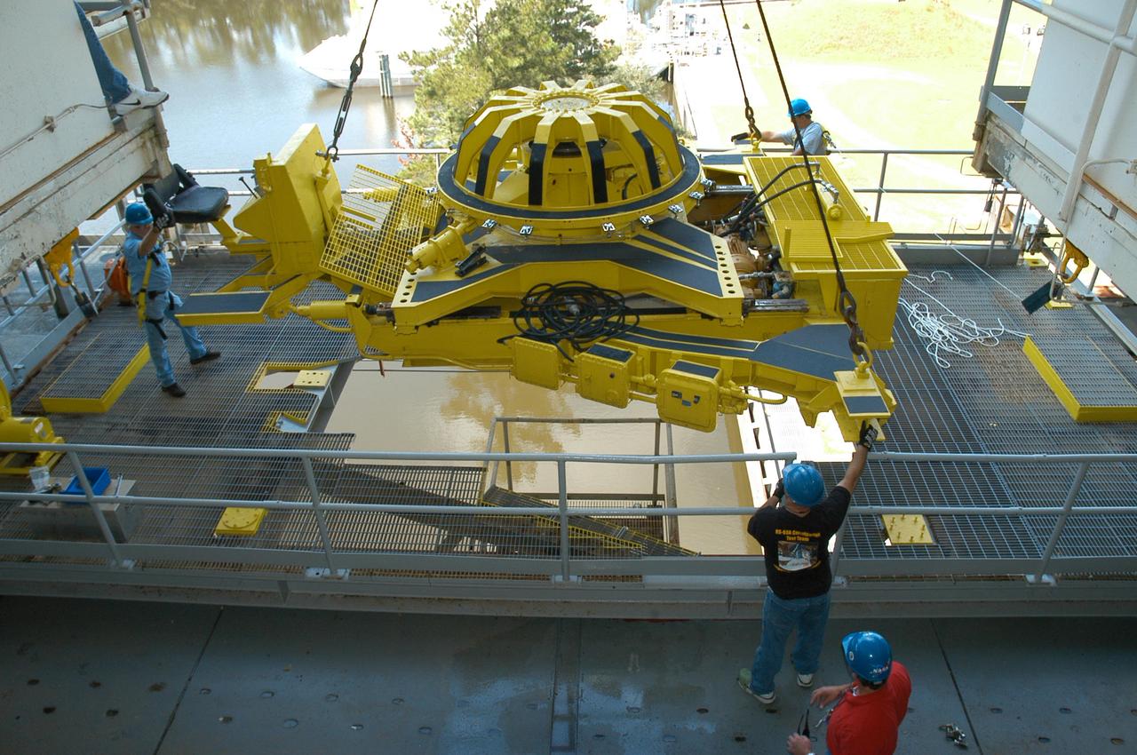 Employees maneuver a vertical engine installer into place on the A-1 Test Stand at Stennis Space Center on Sept. 23. Installation of the equipment was a milestone event as the historic stand underwent modifications for testing the powerpack component of NASA's new J-2X rocket engine in development.