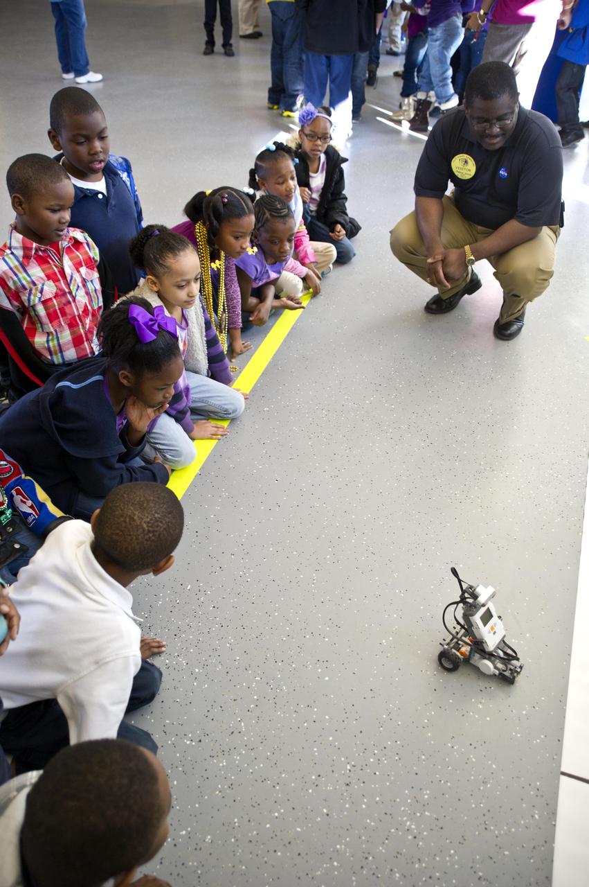 Freddie Douglas, manager of the Stennis Office of Safety and Mission Assurance, joins students to watch a robotic demonstration during activities at Lillie Burney Elementary School in Hattiesburg, Miss., on Jan. 27, 2012. NASA senior staff members from Stennis Space Center visited the school for a morning of activities and outreach to students and school officials.
