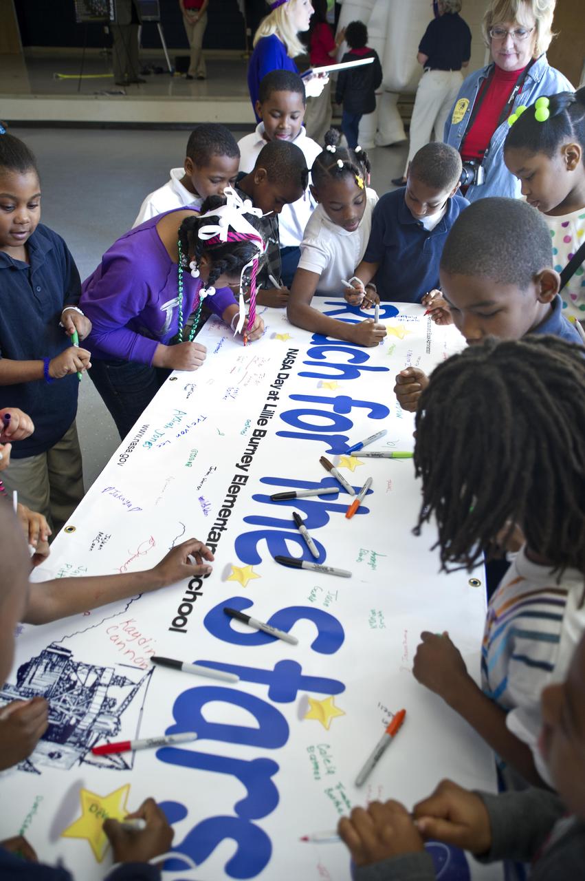 Students at Lillie Burney Elementary School in Hattiesburg, Miss., sign a 'Reach for the Stars' banner to be displayed at their school. NASA senior staff members from Stennis Space Center visited the school Jan. 27, 2012, for a morning of activities and outreach to students and school officials.