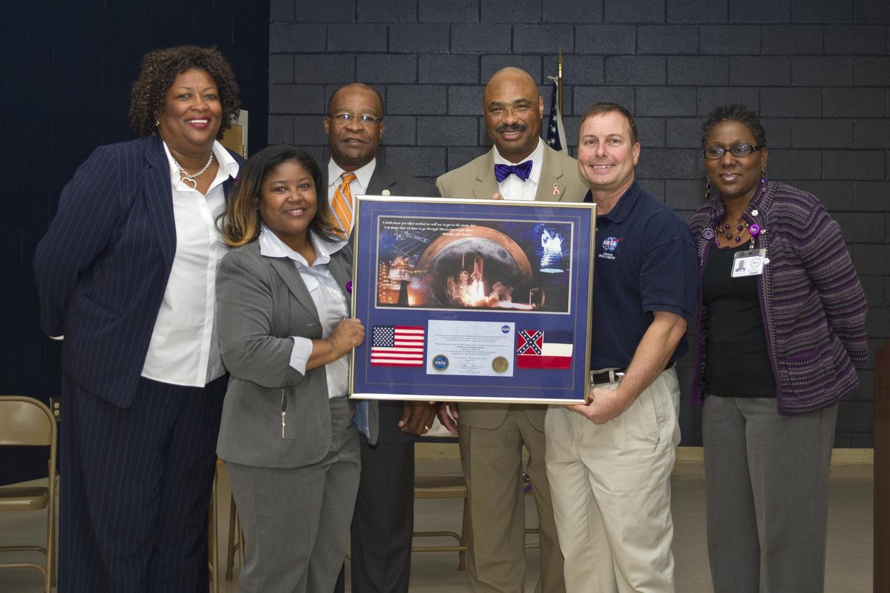 Stennis Deputy Director Rick Gilbrech (second from right) presents a commemorative plaque to Lillie Burney Elementary School officials, including (l to r): Lillie Burney Principal Deborah Smith; Assistant Principal Dr. Bobbie Trussell; Hattiesburg Mayor Johnny DuPree; Hattiesburg Public School District Superintendent James Bacchus; Gilbrech; and District Assistant Superintendent Dr. Edna Thomas. NASA senior staff members from Stennis visited the Hattiesburg, Miss., school Jan. 27, 2012, for a morning of activities and outreach to students and school officials.