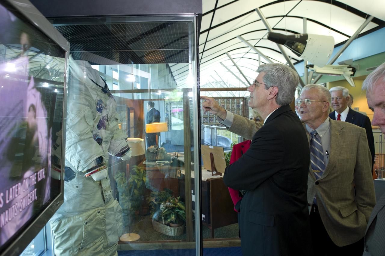 Mississippi Gov. Phil Bryant looks on as Apollo 13 astronaut and INFINITY Science Center Inc. Vice Chairman Fred Haise points out features of the spacesuit he wore on his lunar mission in 1970. The suit is on display at the INFINITY at NASA Stennis Space Center visitor center and museum. The two men toured the facility during ribbon-cutting activities April 11, 2012.