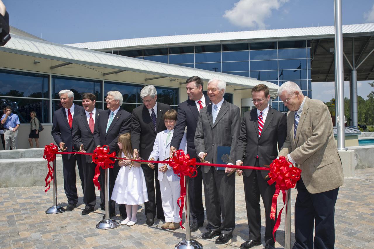 Ceremony participants prepare to cut the ribbon on the INFINITY at NASA Stennis Space Center facility April 11, 2012. Participating in the ceremony were (l to r): Gulfport Mayor and INFINITY Science Center Inc. Chairman George Schloegel; U.S. Rep. Steven Palazzo, R-Miss.; U.S. Sen. Roger Wicker, R-Miss.; Roy S. Estess granddaughter Lauren McKay; Mississippi Gov. Phil Bryant; Leo Seal Jr. grandson Leo Seal IV; Stennis Director Patrick Scheuermann; U.S. Sen. Thad Cochran, R-Miss.; NASA Chief of Staff David Radzanowski; and Apollo 13 astronaut and INFINITY Science Center Inc. Vice Chairman Fred Haise.