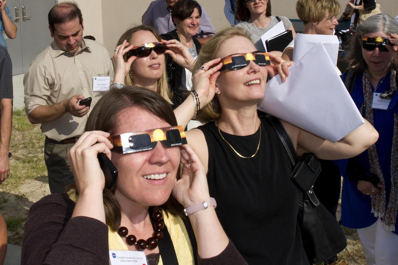 Guests at the INFINITY at NASA Stennis Space Center visitor center use special solar sunglasses to catch a lifetime view of the Venus transit June 5, 2012. The rare celestial event in which the planet Venus traverses the face of the sun will not be visible from Earth again until 2117.