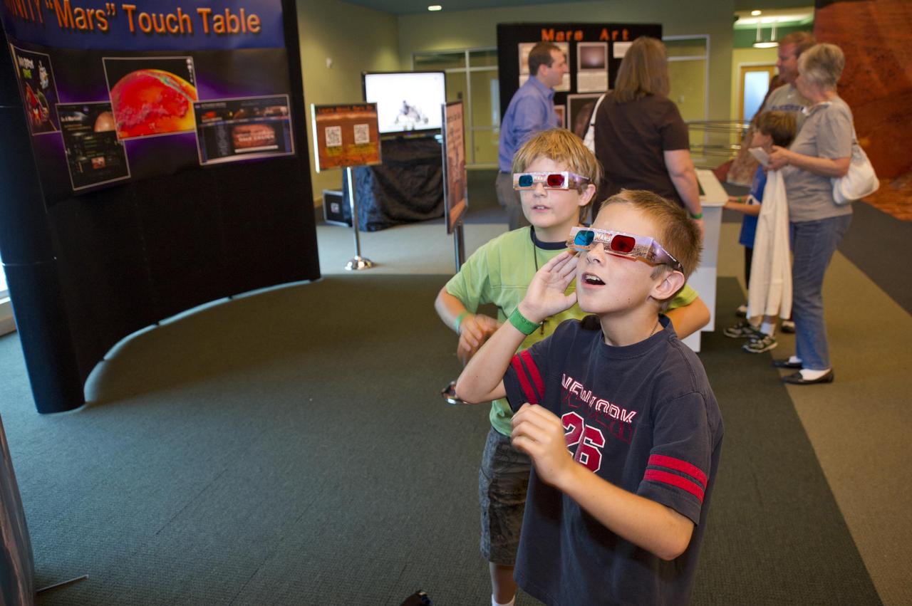 NASA welcomed hundreds of children and accompanying adults to its INFINITY visitor center on Aug. 4, offering Mars-related activities that focused attention on the space agency's Curiosity mission to the Red Planet. Among other attractions, 3-D images from Mars provided 'Wow!' glimpses of the Red Planet. In addition to the Mars activities, visitors were able to tour other space-related exhibits at the center.