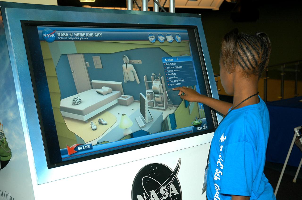 Escatawpa Elementary School student Danisha Dillon of Moss Point, Miss., learns about NASA at the Home and City interactive exhibit at INFINITY Science Center, a NASA visitors center. The facility hosted two days of activity to celebrate the 40th anniversary of the Apollo 17 flight, the last manned space mission to the moon.