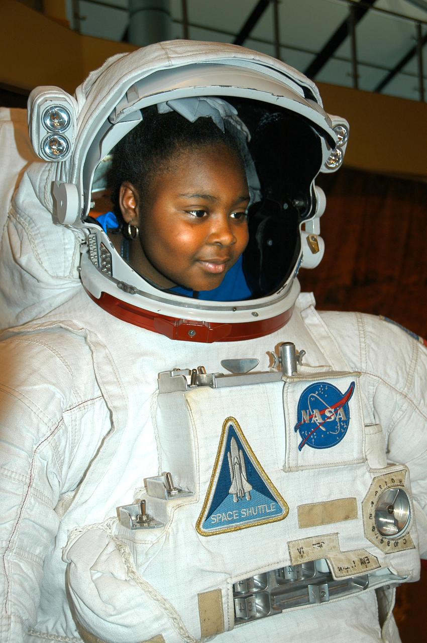 Ariana Lyons from Escatawpa Elementary School in Moss Point, Miss., experiences what it feels like to view the world out of a spacesuit during a visit to INFINITY Science Center, a NASA visitors center, Dec. 7. Lyons joined other young visitors to the facility that day in celebrating the 40th anniversary of the Apollo 17 mission to the moon in 1972.