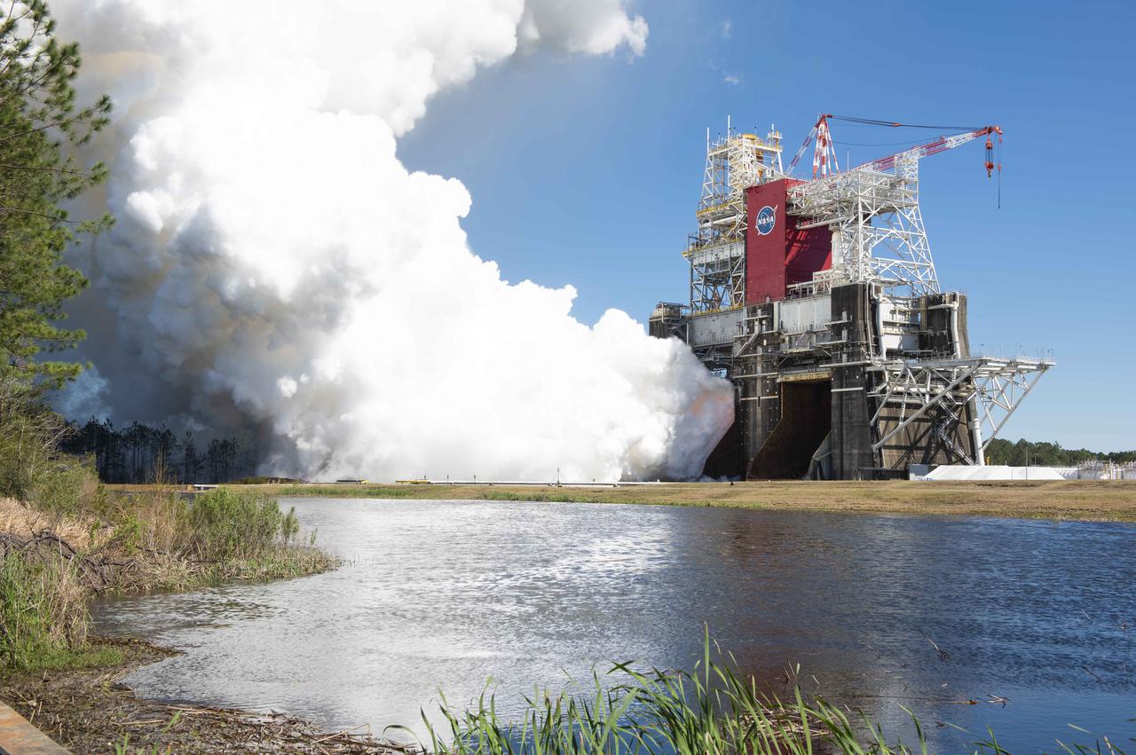 NASA conducts a hot fire test March 18, 2021, of the core stage for the agency’s Space Launch System rocket on the B-2 Test Stand at Stennis Space Center near Bay St. Louis, Mississippi. The hot fire test of the stage’s four RS-25 engines generated a combined 1.6 million pounds of thrust, just as will occur during an actual launch. The hot fire is the final test of the Green Run test series, which represents a comprehensive assessment of the core stage and its integrated systems prior to its launch on the Artemis I mission to the Moon.