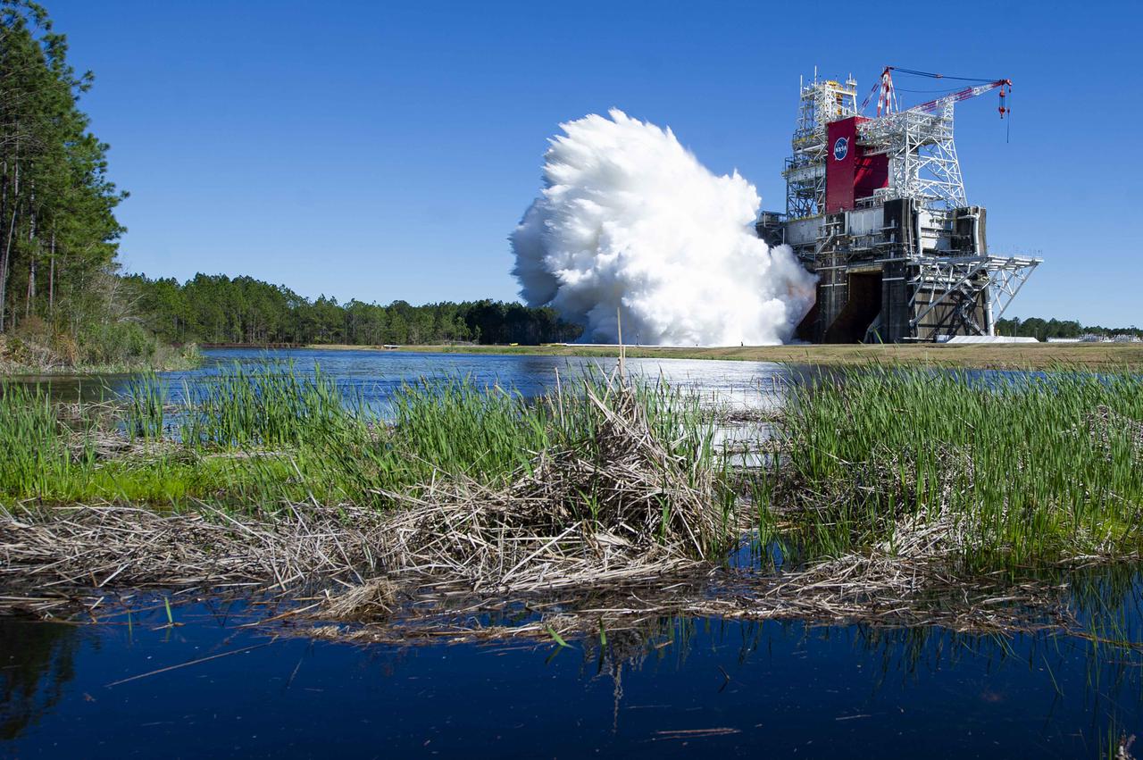 NASA conducts a hot fire test March 18, 2021, of the core stage for the agency’s Space Launch System rocket on the B-2 Test Stand at Stennis Space Center near Bay St. Louis, Mississippi. The hot fire test of the stage’s four RS-25 engines generated a combined 1.6 million pounds of thrust, just as will occur during an actual launch. The hot fire is the final test of the Green Run test series, which represents a comprehensive assessment of the core stage and its integrated systems prior to its launch on the Artemis I mission to the Moon.
