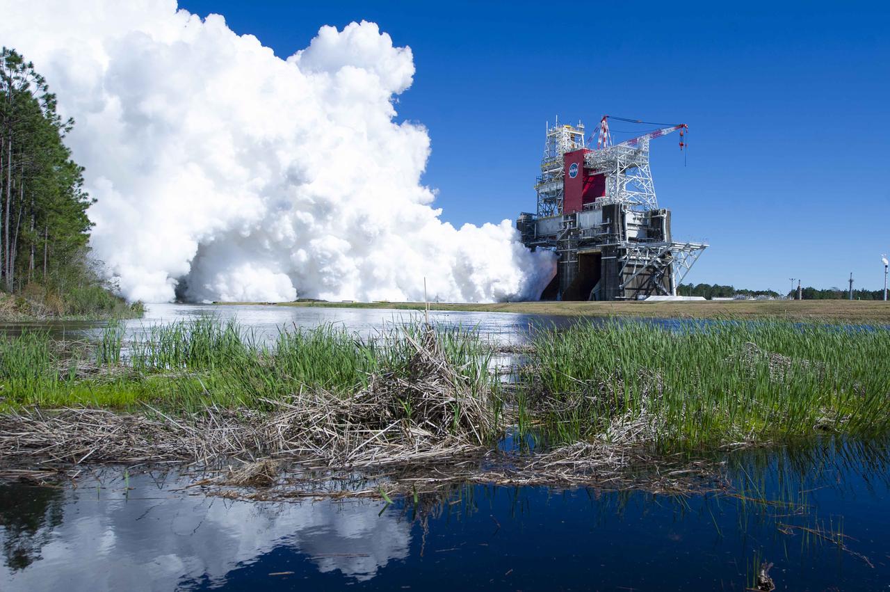 NASA conducts a hot fire test March 18, 2021, of the core stage for the agency’s Space Launch System rocket on the B-2 Test Stand at Stennis Space Center near Bay St. Louis, Mississippi. The hot fire test of the stage’s four RS-25 engines generated a combined 1.6 million pounds of thrust, just as will occur during an actual launch. The hot fire is the final test of the Green Run test series, which represents a comprehensive assessment of the core stage and its integrated systems prior to its launch on the Artemis I mission to the Moon.
