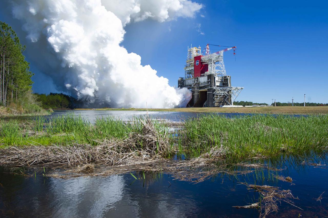 NASA conducts a hot fire test March 18, 2021, of the core stage for the agency’s Space Launch System rocket on the B-2 Test Stand at Stennis Space Center near Bay St. Louis, Mississippi. The hot fire test of the stage’s four RS-25 engines generated a combined 1.6 million pounds of thrust, just as will occur during an actual launch. The hot fire is the final test of the Green Run test series, which represents a comprehensive assessment of the core stage and its integrated systems prior to its launch on the Artemis I mission to the Moon.