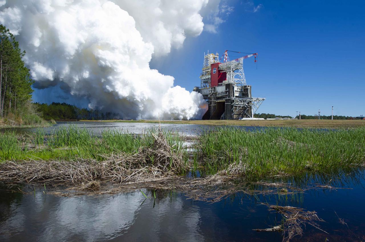 NASA conducts a hot fire test March 18, 2021, of the core stage for the agency’s Space Launch System rocket on the B-2 Test Stand at Stennis Space Center near Bay St. Louis, Mississippi. The hot fire test of the stage’s four RS-25 engines generated a combined 1.6 million pounds of thrust, just as will occur during an actual launch. The hot fire is the final test of the Green Run test series, which represents a comprehensive assessment of the core stage and its integrated systems prior to its launch on the Artemis I mission to the Moon.