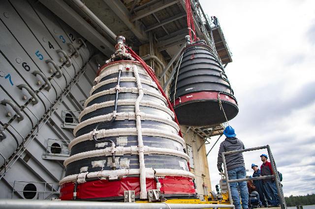 Teams at NASA’s Stennis Space Center install a second production nozzle, left, on Feb. 6 to gather additional performance data on the RS-25 certification engine at the Fred Haise Test Stand.