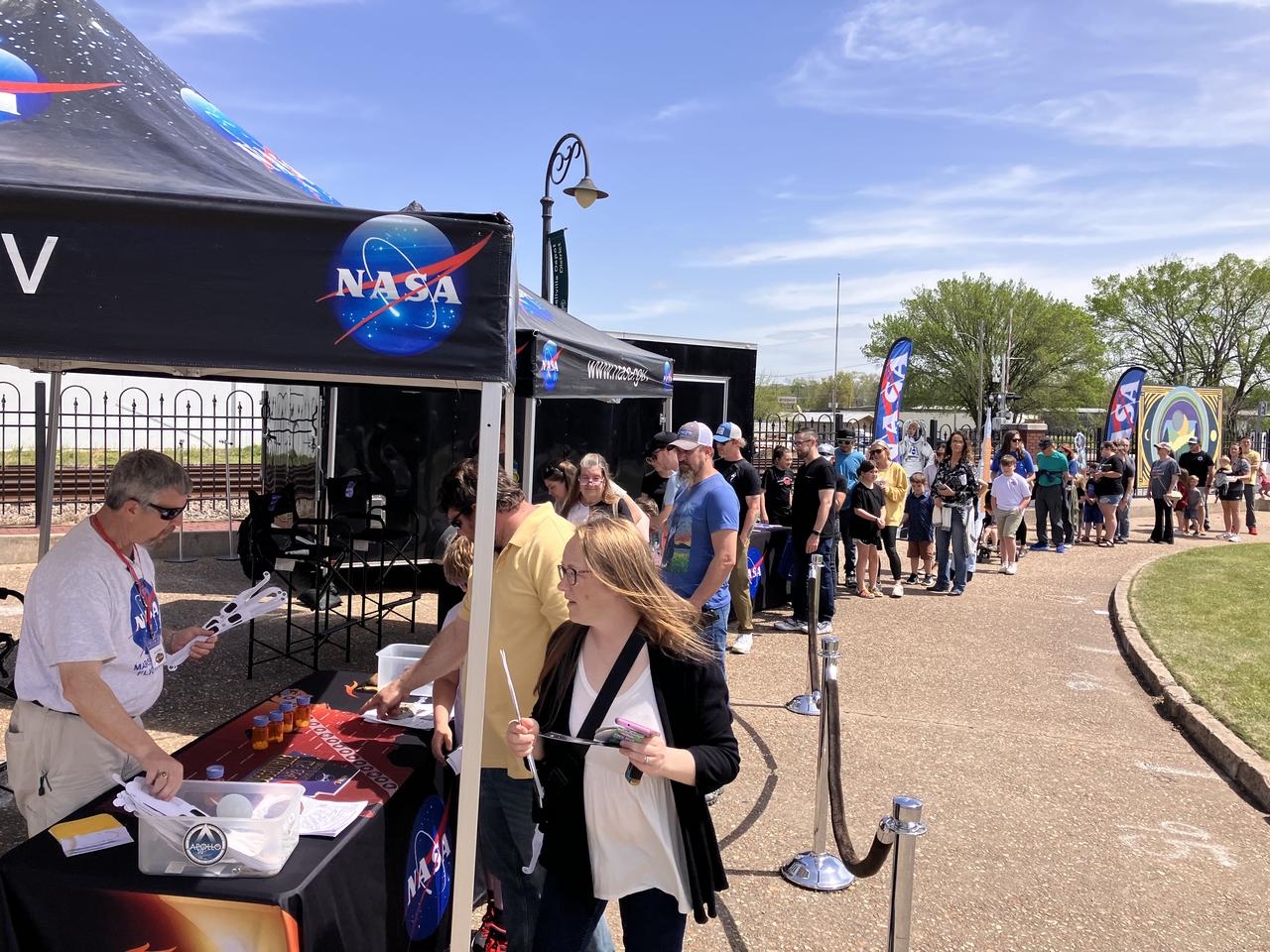 NASA gives out solar eclipse glasses for people to safely view the eclipse on April 8 in Russellville, Arkansas.