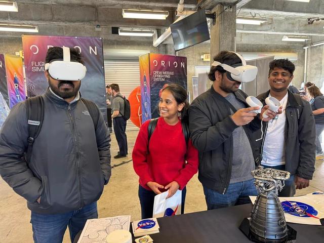 Visitors enjoy an RS-25 engine test using the virtual reality goggles at the NASA Stennis booth during solar eclipse activities at the Indianapolis Motor Speedway in Indiana on April 8.