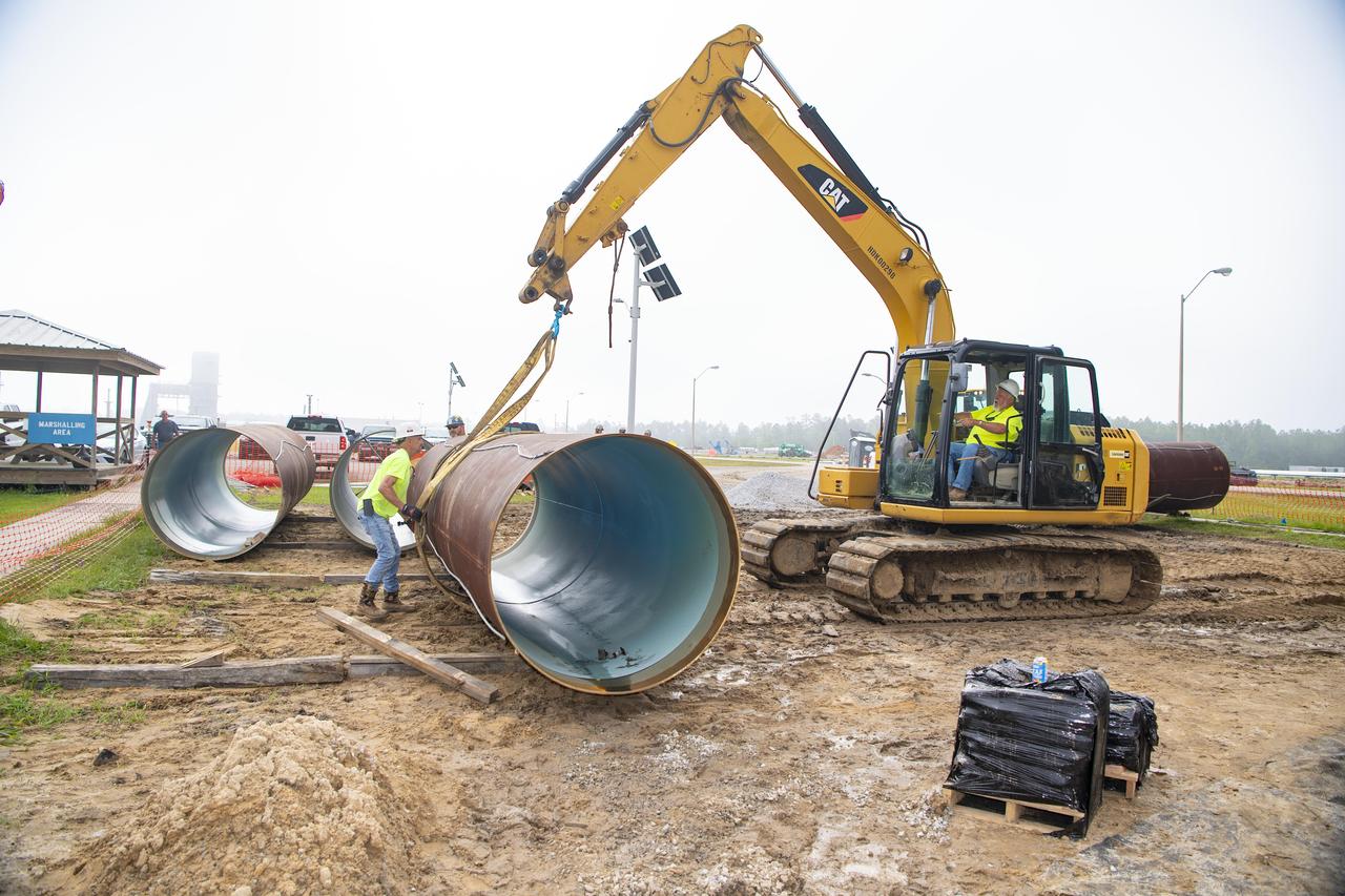 Crews lift a new pipeline liner section near the Fred Haise Test Stand on May 1 in the last phase of updating the original test complex water system at NASA’s Stennis Space Center.