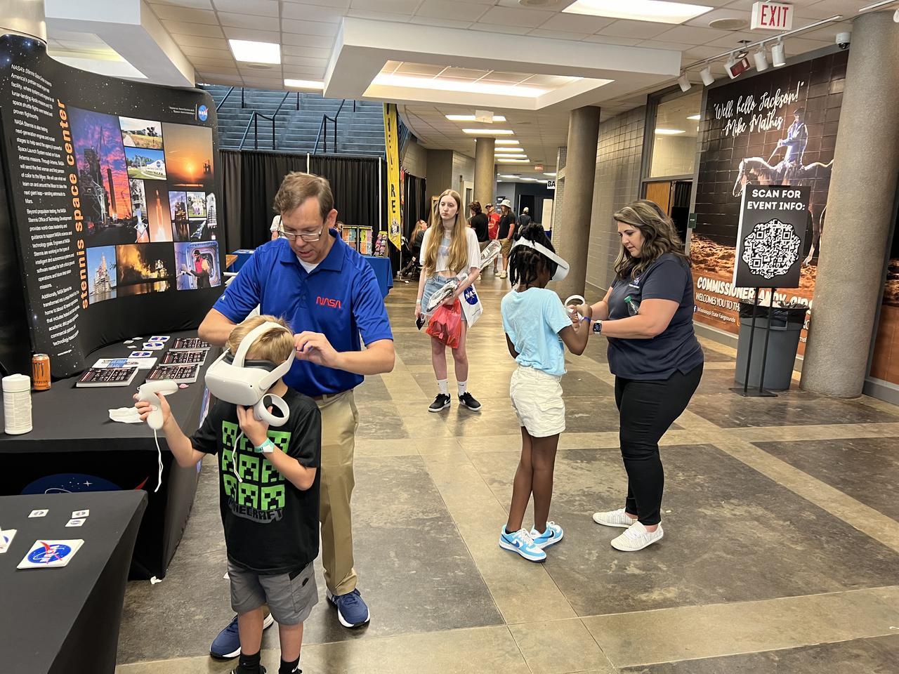 NASA Stennis budget analyst Rebecca Mataya, right, and NASA Stennis engineer Paul Fuller assist young space fans with the NASA virtual reality experience at the Mississippi Comic Convention in Jackson, Mississippi, on June 22 at the Mississippi Trade Mart and Coliseum. 