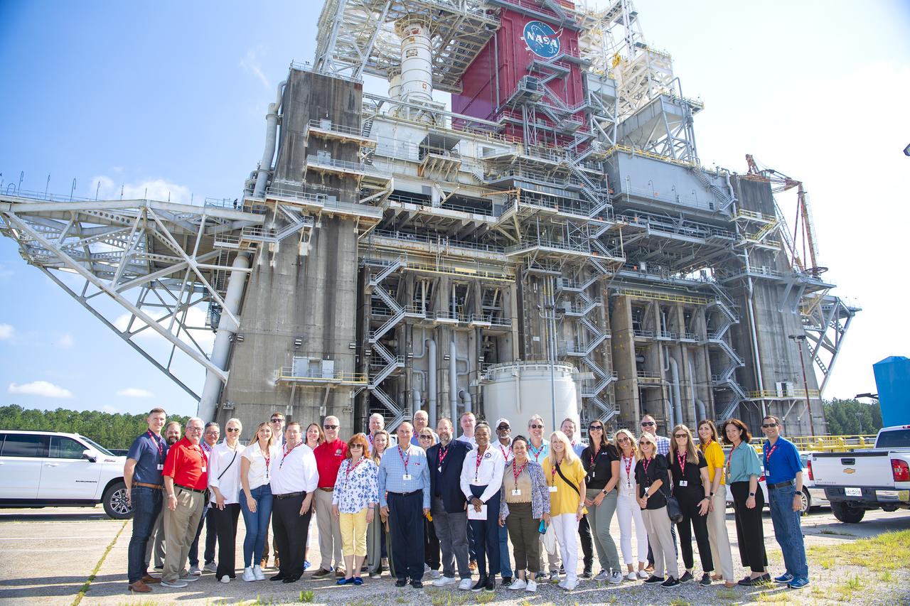 Members of the Aerospace States Association stand at the Thad Cochran Test Stand on June 25 during a visit to NASA’s Stennis Space Center. The group came to the south Mississippi NASA center during the Aerospace States Association conference in New Orleans June 24-27. NASA Stennis will use the Thad Cochran Test Stand (B-2) to test the exploration upper stage, a more powerful second stage to send the Orion spacecraft to deep space on NASA’s SLS (Space Launch System) rocket, ahead of its expected flight on the Artemis IV mission.