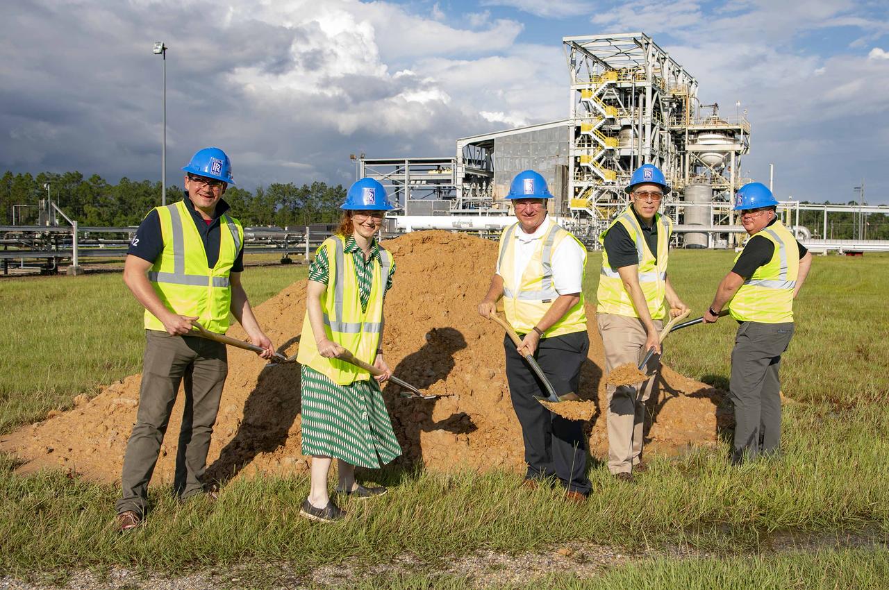 : NASA’s Stennis Space Center continues to support commercial companies and benefit the aerospace industry. The latest example comes as officials from NASA Stennis and Rolls-Royce break ground for the E-1 Hydrogen Test Pad, located at the NASA Stennis E-Complex Test Facility, during a June 27 ceremony. The site will be where Rolls-Royce conducts hydrogen testing for the Pearl 15 engine. The Pearl 15 engine helps power the Bombardier Global 5500 & 6500 aircraft and enables top speeds of Mach 0.90. Groundbreaking participants include (left to right): Adam Newman, Rolls-Royce chief engineer of hydrogen technology; Deborah Robinson, Rolls-Royce director of test and experimental engineering; Troy Frisbie, NASA Stennis legislative affairs specialist and chief of staff; Dan Lyon, Rolls-Royce North America general manager; and Steven Blake, Rolls-Royce North America indirect purchasing, global commodity manager.