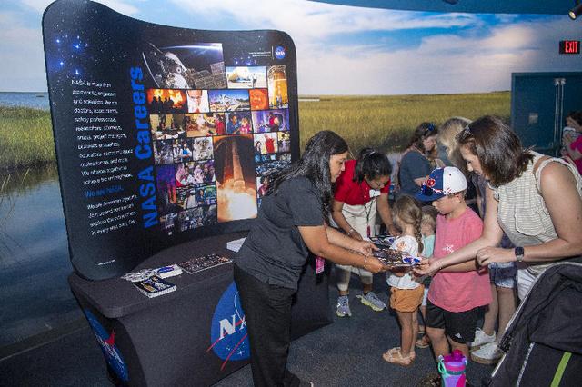 NASA representatives provide memorabilia to Audubon Aquarium visitors in New Orleans on July 5. NASA hosted an information/interactive exhibit at the aquarium in conjunction with NASA activities at the 30th annual ESSENCE Fest in New Orleans during the Fourth of July weekend.