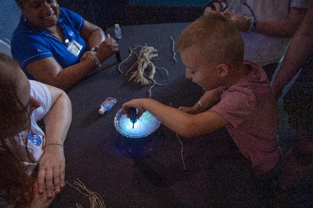 An Audubon Aquarium visitor in New Orleans is all smiles while participating in the solar bead activity provided by NASA on July 5. NASA hosted an information/interactive exhibit at the aquarium in conjunction with NASA activities at the 30th annual ESSENCE Fest in New Orleans during the Fourth of July weekend.
