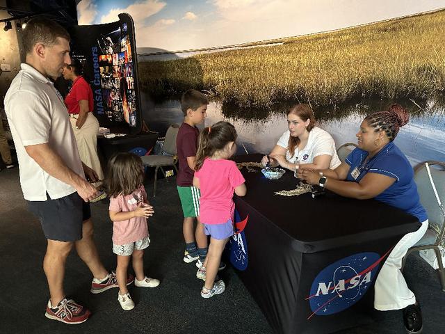 NASA representatives teach visitors to the Audubon Aquarium in New Orleans about the Sun on July 5. NASA hosted an information/interactive exhibit at the aquarium in conjunction with NASA activities at the 30th annual ESSENCE Fest in New Orleans during the Fourth of July weekend.