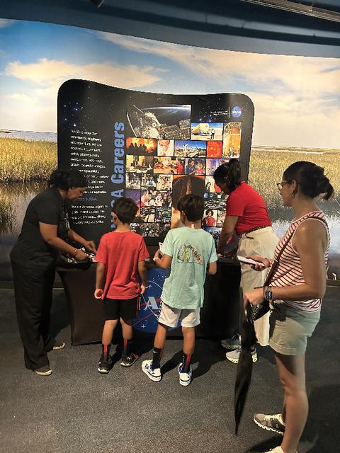 NASA representatives provide information about the space agency to Audubon Aquarium visitors in New Orleans on July 5. NASA hosted an information/interactive exhibit at the aquarium in conjunction with NASA activities at the 30th annual ESSENCE Fest in New Orleans during the Fourth of July weekend.