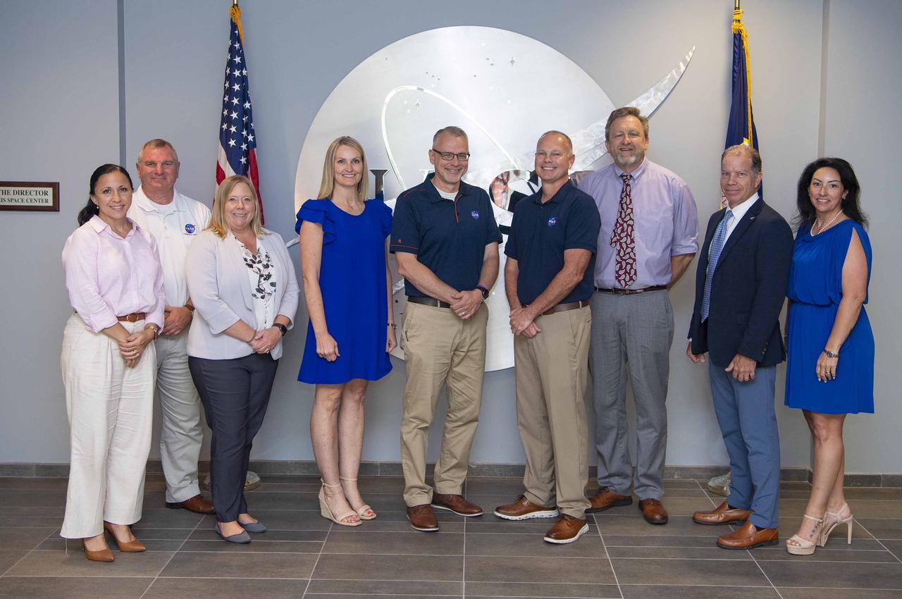 NASA Associate Administrator Jim Free stands with leaders from NASA Stennis and the NASA Shared Services Center during a visit on July 16 to the south Mississippi site. Free also met with representatives of commercial companies engaged in onsite propulsion activities. Pictured left to right is Jill Castiglione, NASA Stennis executive assistant; Troy Frisbie, NASA Stennis chief of staff; Nikki Tubbs, NASA Shared Services Center director of support operations; Anita Harrell, NASA Shared Services Center executive director; Free; John Bailey, NASA Stennis director; Rodney McKellip, NASA Stennis associate director; Troy Taylor, NASA Shared Services Center deputy director of service delivery; and Jessie Shiyou, NASA Shared Services Center executive assistant.
