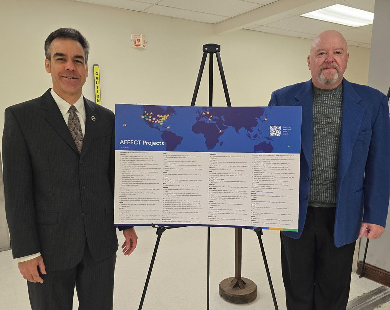 NASA Energy Program Manager for Facility Projects Wayne Thalasinos, left, stands with NASA Stennis Sustainability Team Lead Alvin Askew at the U.S. Department of Energy in Washington, D.C., on Oct. 30. The previous day, the Department of Energy announced NASA Stennis will receive a $1.95 million grant for an energy conservation project at the south Mississippi center. The Stennis Sustainability Team consists of NASA personnel and contract support. NASA members include Askew, Missy Ferguson and Teenia Perry. Contract members include Jordan McQueen (Synergy-Achieving Consolidated Operations and Maintenance); Michelle Bain (SACOM); Matt Medick (SACOM); Thomas Mitchell (SACOM); Lincoln Gros (SACOM), and Erik Tucker (Leidos).