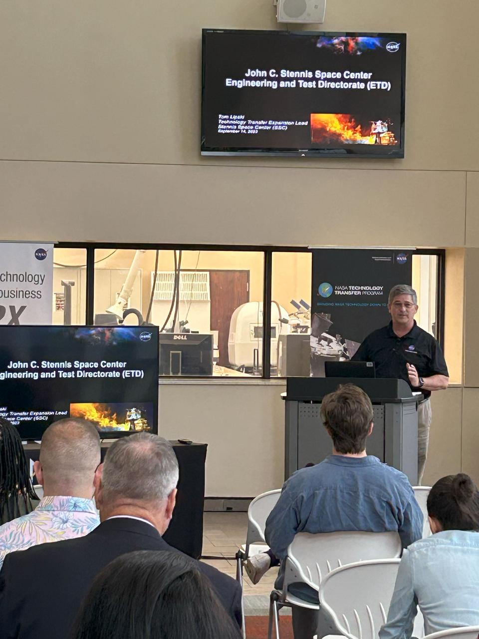 Tom Lipski, NASA Stennis Technology Transfer Expansion team lead, speaks at the “A Day with NASA” event at The Accelerator in Hattiesburg, Mississippi, on Nov. 7. NASA speakers focused on providing updates on agency resources available to help companies grow and on different ways to do business with the agency. They also offered information about how businesses could build partnerships with the agency to commercialize NASA-developed technologies. Participants had the opportunity to meet one-on-one with members of the NASA Stennis business and technology team as well. The Mississippi Polymer Institute, with funding from the Mississippi Manufacturer’s Association Manufacturing Extension Partnership, hosted the event.