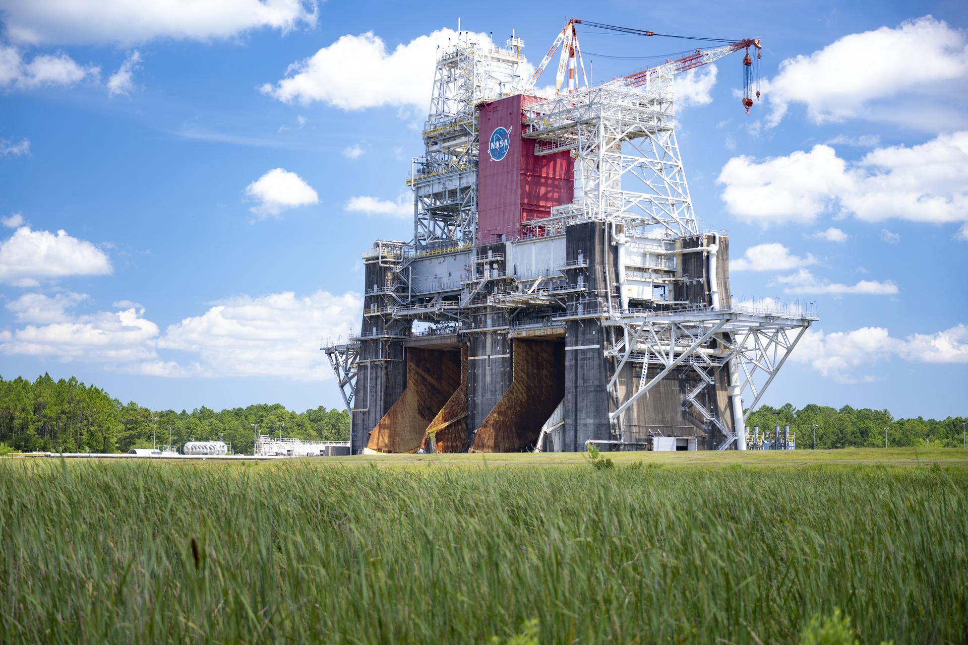 An image shows the Thad Cochran Test Stand (B-1/B-2) at NASA’s Stennis Space Center near Bay St. Louis, Mississippi, on July 7. The test stand features dual, vertical firing positions built in the 1960s to test Saturn V rocket stages that carried humans to the Moon during the Apollo program. The B 1 position, right, is equipped for single engine tests, while the B 2 position is designed to test full rocket stages.