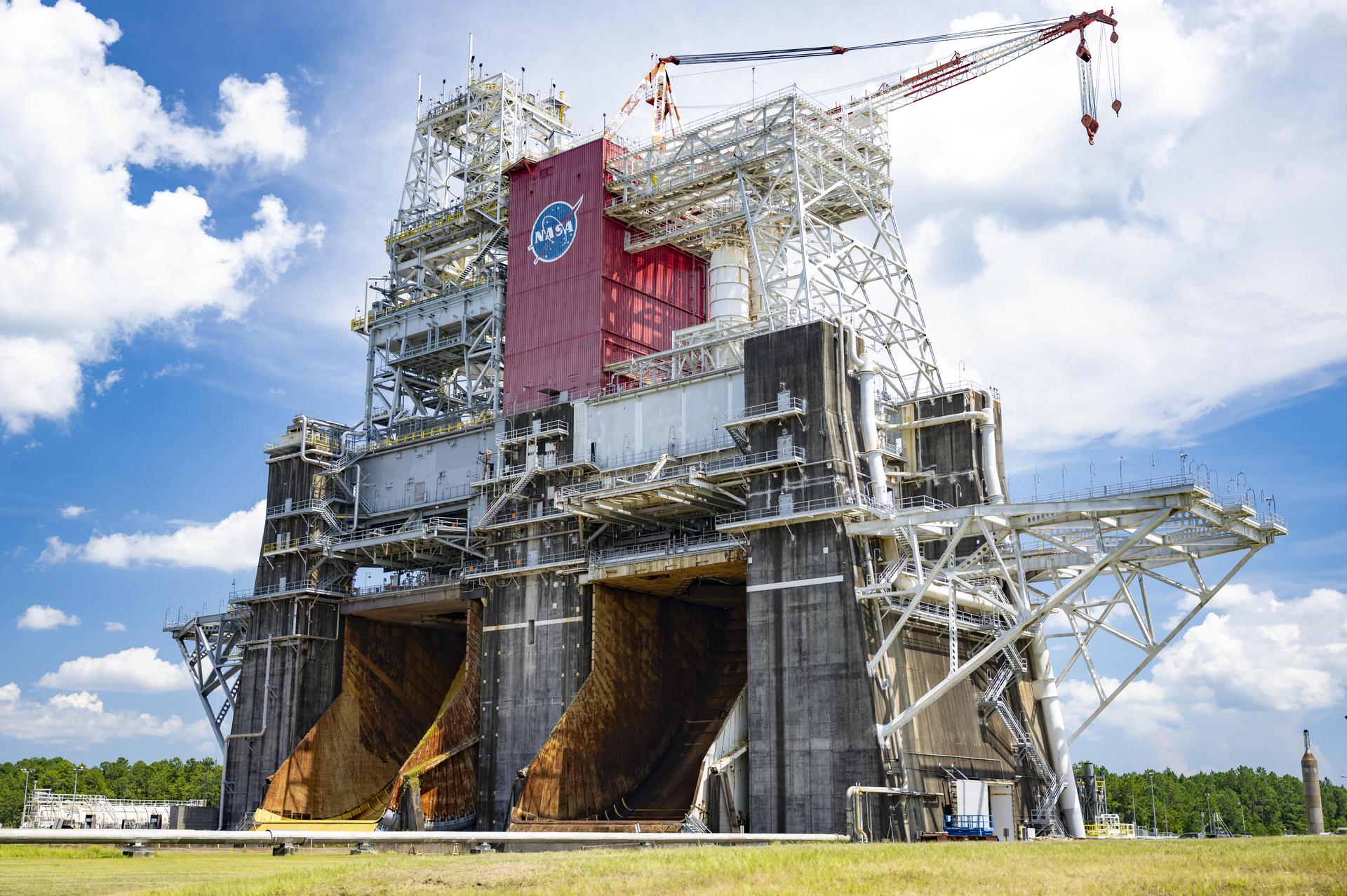 An image shows the Thad Cochran Test Stand (B-1/B-2) at NASA’s Stennis Space Center near Bay St. Louis, Mississippi, on July 7. The test stand features dual, vertical firing positions built in the 1960s to test Saturn V rocket stages that carried humans to the Moon during the Apollo program. The B 1 position, right, is equipped for single engine tests, while the B 2 position is designed to test full rocket stages.