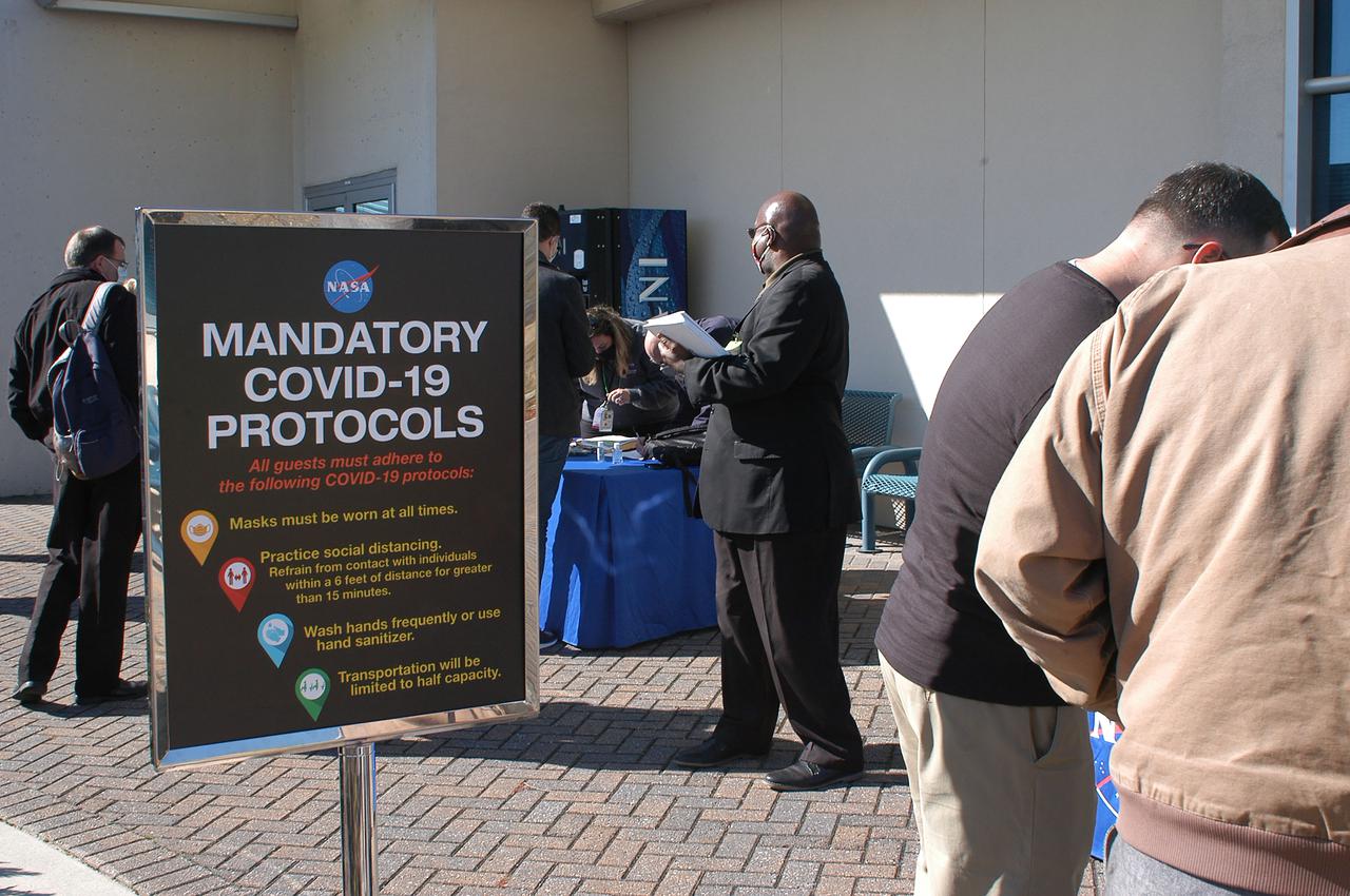 A posted sign outlines COVID-19 protocol for media and guests arriving to view the Green Run hot fire test of the core stage for NASA’s Space Launch System (SLS) rocket at Stennis Space Center near Bay St. Louis, Mississippi, on Saturday, January 16, 2021. NASA conducted a hot fire test of the core stage’s four RS-25 engines on the B-2 Test Stand at Stennis. Scheduled for as long as eight minutes, the engines fired for a little more than one minute to generate a combined 1.6 million pounds of thrust, just as will occur during an actual launch. The hot fire is the final test of the Green Run test series, a comprehensive assessment of the SLS core stage prior to launching the Artemis I mission to the Moon.
