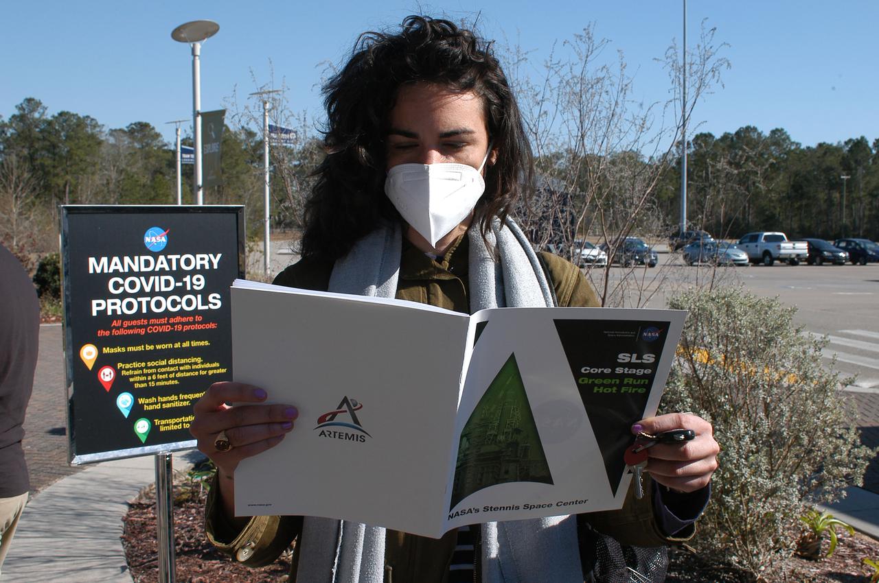 A guest reviews a commemorative Green Run booklet after arriving to view the Green Run hot fire test of the core stage for NASA’s Space Launch System (SLS) rocket at Stennis Space Center near Bay St. Louis, Mississippi, on Saturday, January 16, 2021. NASA conducted a hot fire test of the core stage’s four RS-25 engines on the B-2 Test Stand at Stennis. Scheduled for as long as eight minutes, the engines fired for a little more than one minute to generate a combined 1.6 million pounds of thrust, just as will occur during an actual launch. The hot fire is the final test of the Green Run test series, a comprehensive assessment of the SLS core stage prior to launching the Artemis I mission to the Moon.