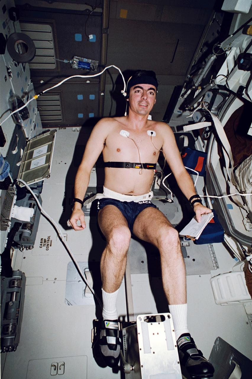 STS046-24-025 (31 July-8 Aug. 1992) --- Astronaut Andrew M. Allen, STS-46 pilot, exercises on the bicycle ergometer device on the flight deck of the Space Shuttle Atlantis as it makes one of its 127 total orbits for the eight-day mission. Allen, equipped with sensors for monitoring his biological systems during the run, was joined by four other NASA astronauts and two European scientists on the mission.