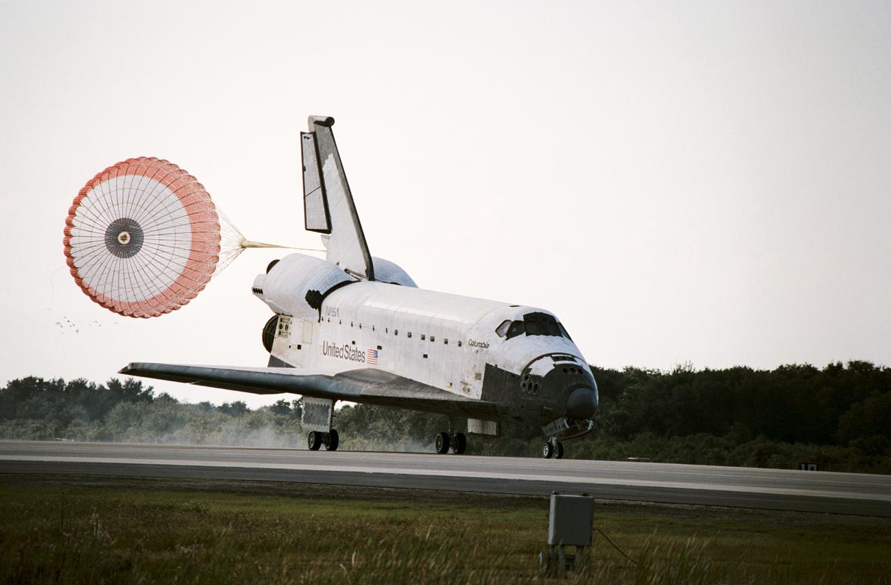 STS052-S-099 (1 Nov. 1992) --- This three-quarter front view shows the Space Shuttle Columbia just after deployment of the drag chute during landing at KSC's Shuttle Landing Facility. Onboard were a crew of five NASA astronauts and a Canadian payload specialist. Landing occurred at 9:05:53 a.m. (EST), November 1, 1992. Crewmembers are astronauts James D. Wetherbee, Michael A. Baker, Tamara E. Jernigan, Charles L. (Lacy) Veach and William M. Shepherd along with payload specialist Steven G.  MacLean. The photo was taken with a 35mm camera.