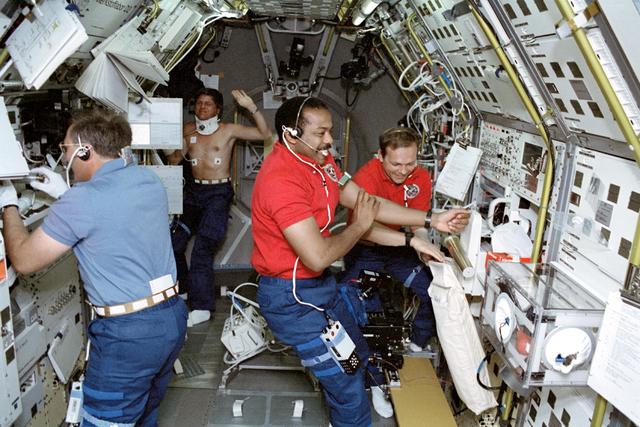 NASA image: STS-55 crewmembers work in the SL-D2 module onboard OV-102