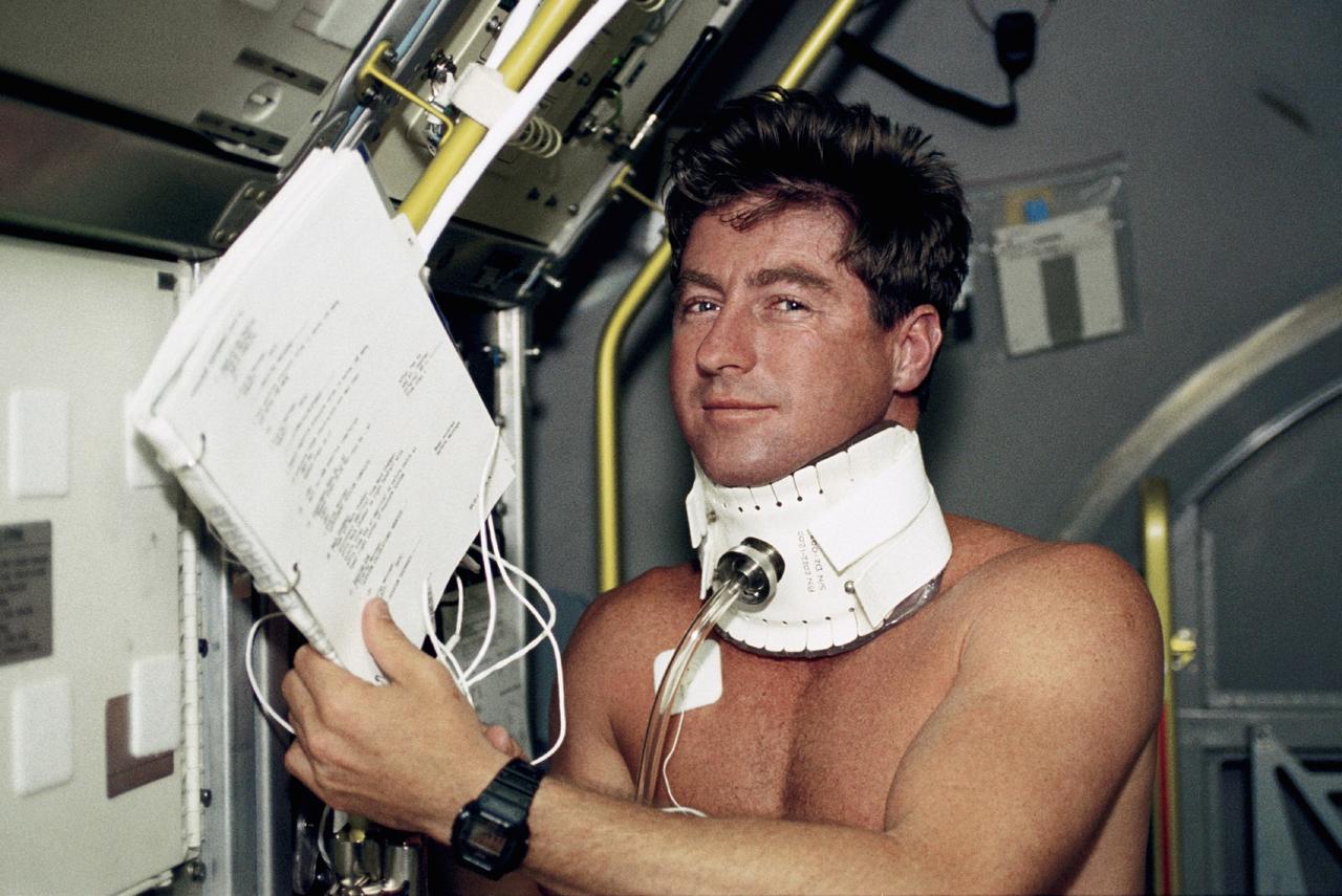 STS055-233-019 (26 April-6 May 1993) --- Terence T. (Tom) Henricks, STS-55 pilot, wears a special collar for a space adaptation experiment in the science module onboard the Earth-orbiting Space Shuttle Columbia. The Baroreflex (BA) experiment is designed to investigate the theory that light-headedness and a reduction in blood pressures upon standing after landing may arise because the normal reflex system regulating blood pressure behaves differently after having adapted to a microgravity environment. These space-based measurements of the baroreflex will be compared to ground measurements to determine if microgravity affects the reflex.