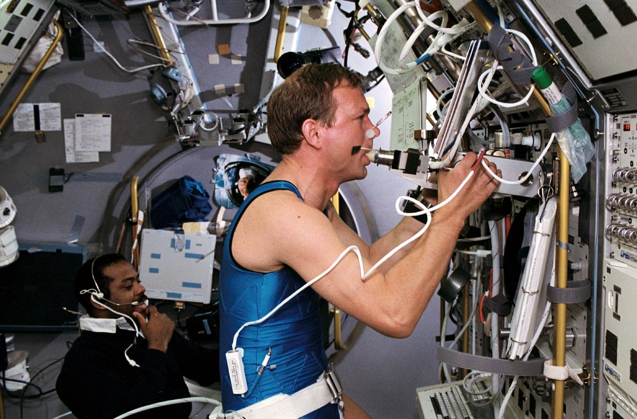 STS055-45-017 (26 April-6 May 1993) --- Hans Schlegel (foreground) participates in the ongoing investigation of human physiology under microgravity conditions as he works out on the ergometer at the Anthrorack. Monitoring the "run" is astronaut Bernard A. Harris, Jr., STS-55 mission specialist. Schlegel is one of two payload specialists representing the German Aerospace Research Establishment (DLR) on the Spacelab D-2 mission.