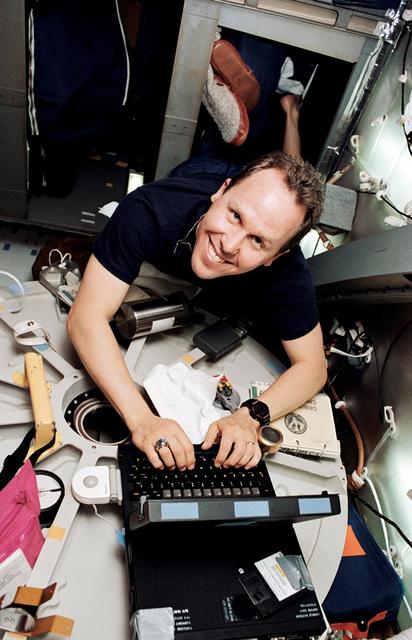 NASA image: Astronaut Thomas Jones anchored to bunk facility while working on computer