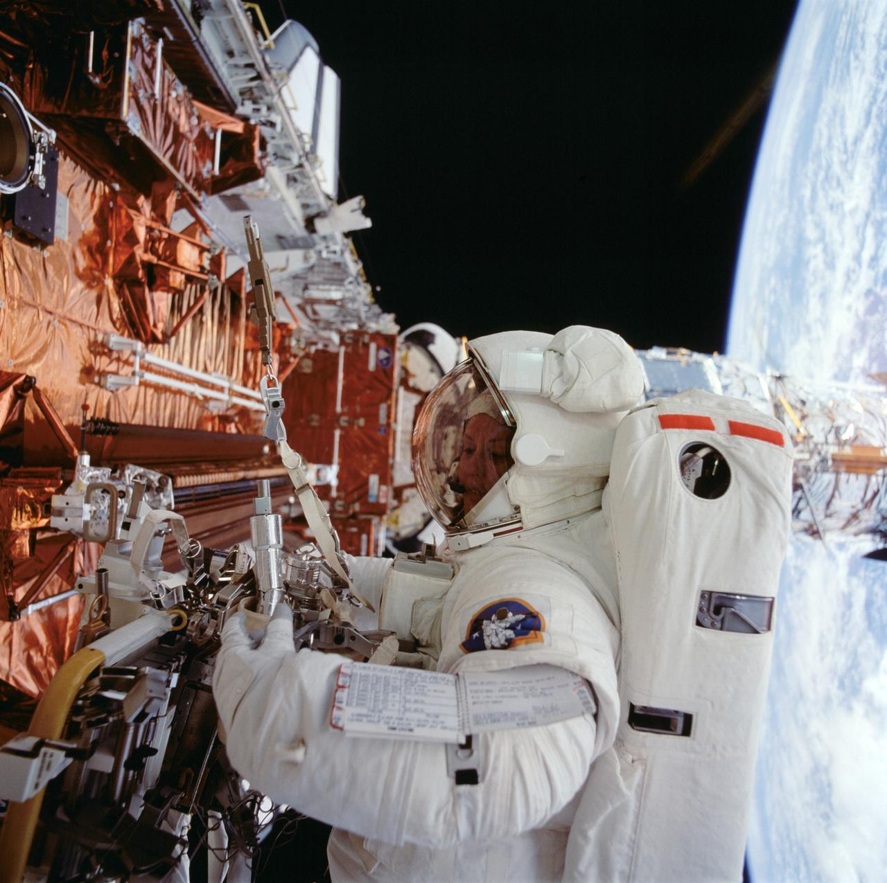 STS061-098-000K (8 Dec. 1993) --- Astronaut Kathryn C. Thornton works with equipment associated with servicing chores on the Hubble Space Telescope (HST) during the fourth extravehicular activity (EVA) on the eleven-day mission.