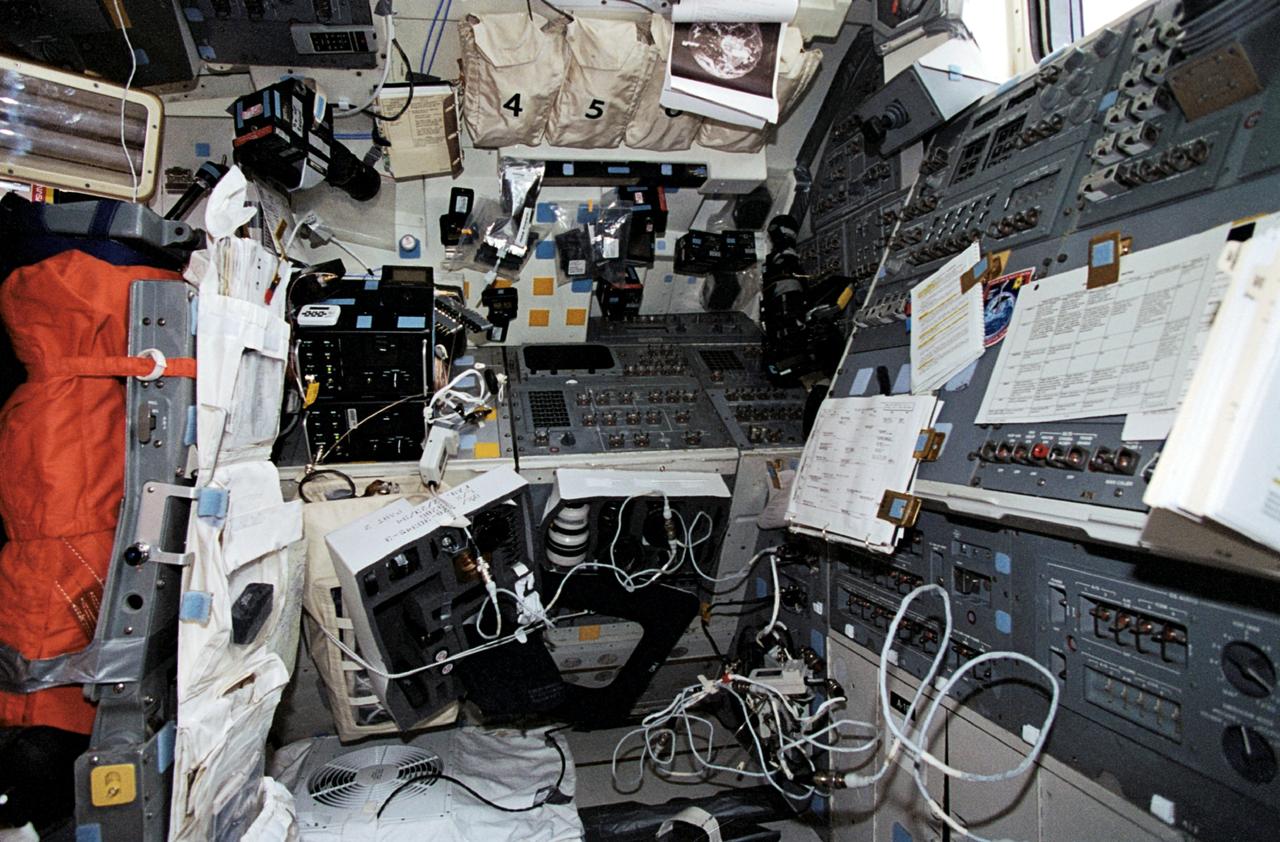 STS062-17-034 (4-18 March 1994) --- This scene, resembling a photographer's studio/laboratory, actually shows the aft flight deck of the Earth-orbiting Space Shuttle Columbia. A variety of cameras, lenses, visual aids and other gear are seen stowed around the flight deck. The five astronaut crew members devoted a large portion of their on-duty time at this workstation using some of this photographic equipment to record Earth imagery.