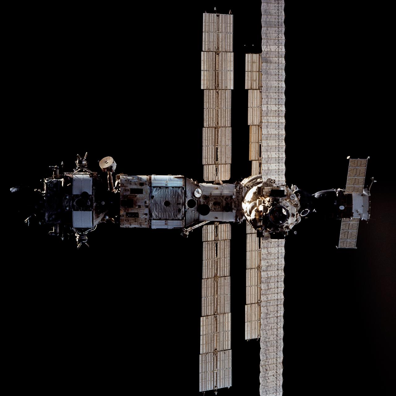 STS063-712-017 (6 Feb. 1995) --- Russia's Mir Space Station during rendezvous operations with the Space Shuttle Discovery.  Docked at the bottom of the Mir facility is a Soyuz spacecraft.  On the opposite end (almost cropped out of frame at top) is a Progress spacecraft.  Onboard the Space Shuttle Discovery were astronauts James D. Wetherbee, mission commander; Eileen M. Collins, pilot; Bernard A. Harris, Jr., payload commander; C. Michael Foale and Janice E. Voss, mission specialists; along with cosmonaut Vladimir G. Titov, mission specialist.