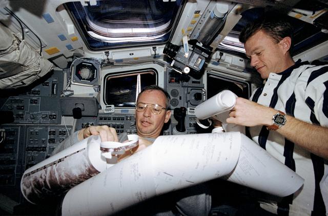 NASA image: Commander Brian Duffy and Pilot Brent Jett organize the morning messages