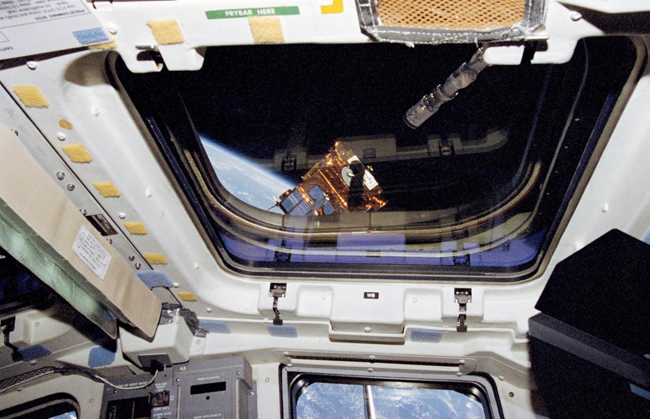 STS072-320-014 (17 Jan. 1996) --- The end effect of the Space Shuttle Endeavour's Remote Manipulator System (RMS) is about to grapple the Office of Aeronautics and Space Technology's (OAST) -- Flyer satellite.  The view was recorded with a 35mm camera aimed through one of Endeavour's overheard windows on the aft flight deck.